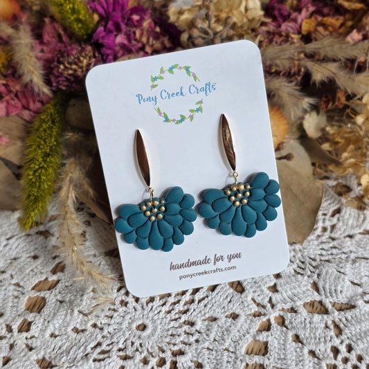 Floral statement in dark teal with gold accent findings