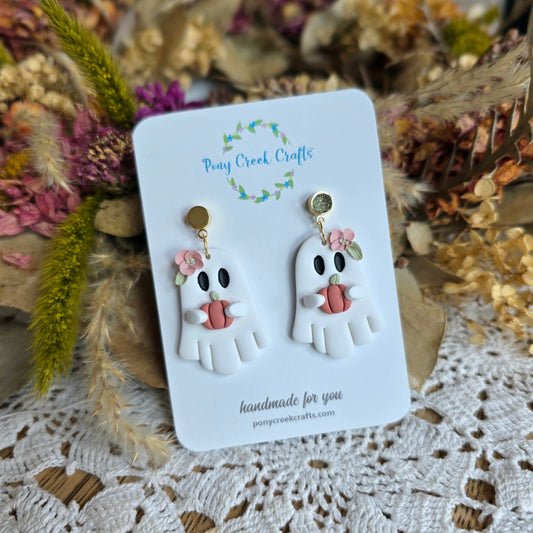 Ghost holding pumpkin with floral accents