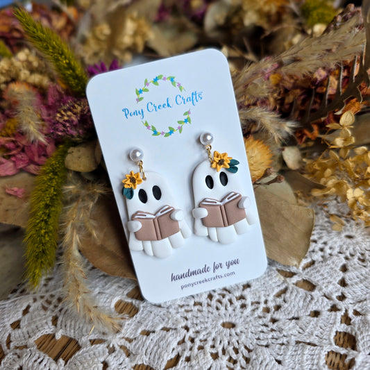 Ghost holding book with floral accents