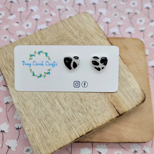 White and black cow print heart studs