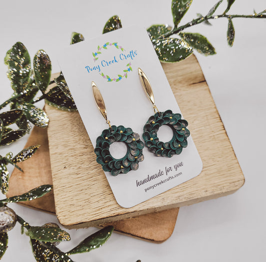 Holiday wreath earrings in dark green with shimmer and gold accent berries