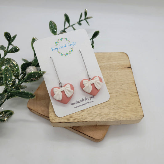 Pink hearts with white bow dangle earrings