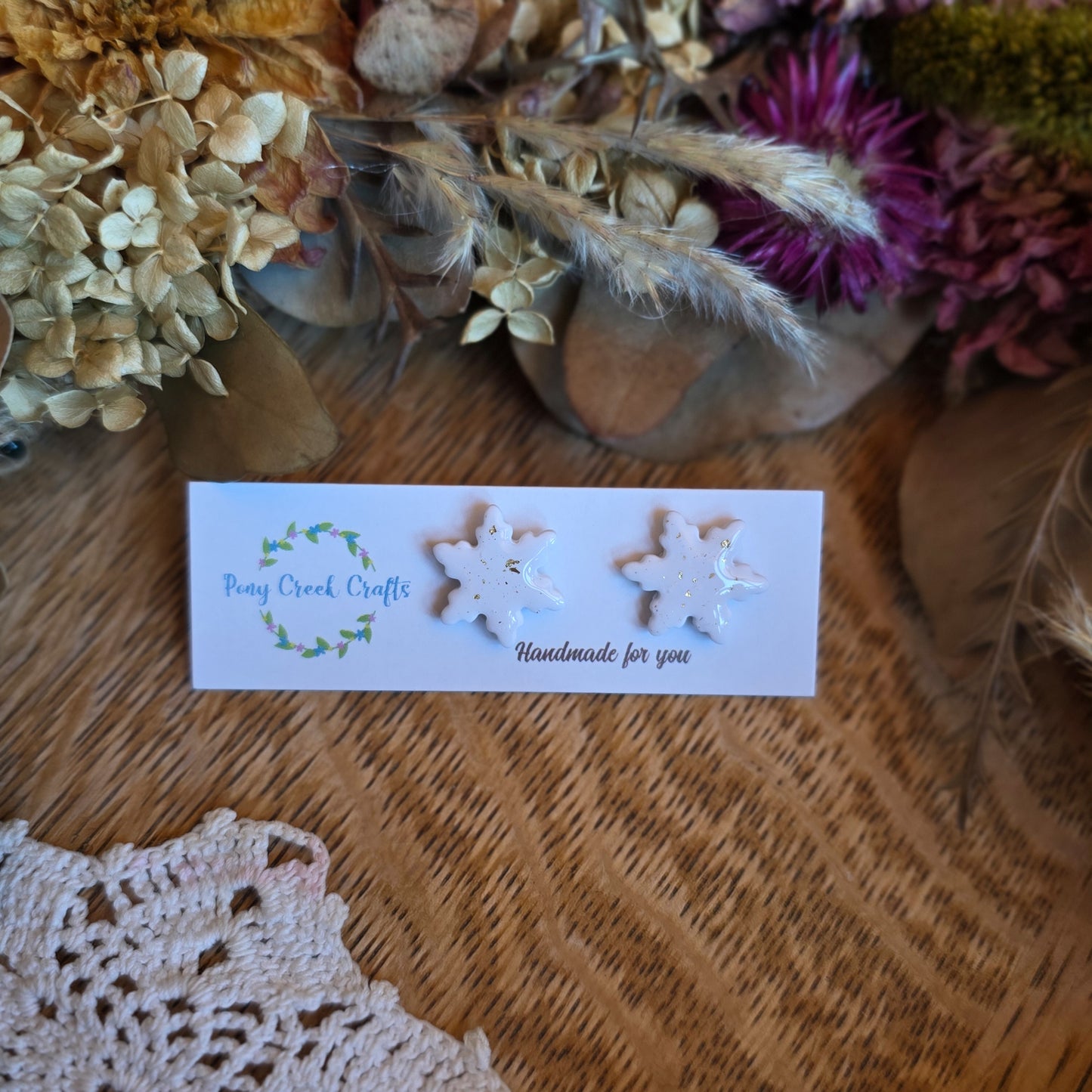 White and gold accent snowflake stud earrings