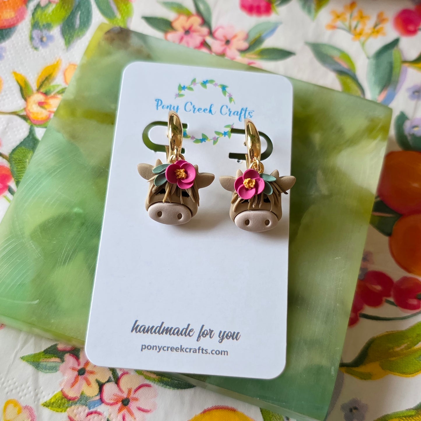 Highland cow earrings with floral accent